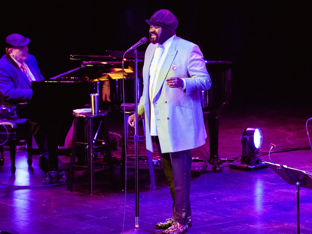 A performance shot of Gregory Porter singing on stage at Kings Theatre.