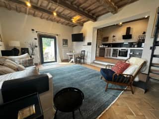 The tobacco barn sitting room with view through to the kitchen.